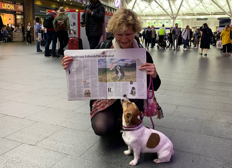 Dr Arielle Griffiths with The Guardian newspaper and Jack Russell Minnie at Kings Cross Station