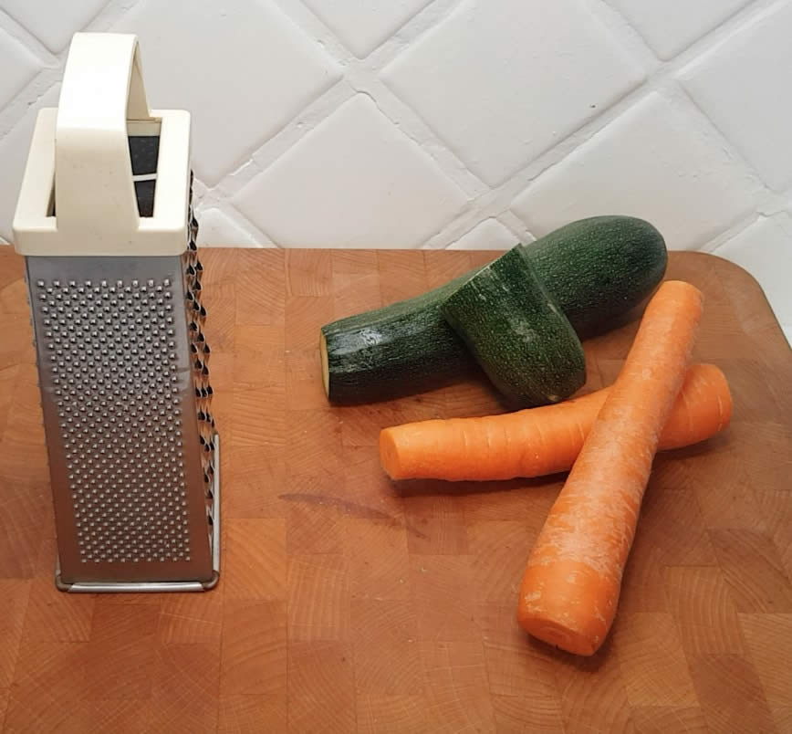 Finely chop or grate the courgettes and carrots